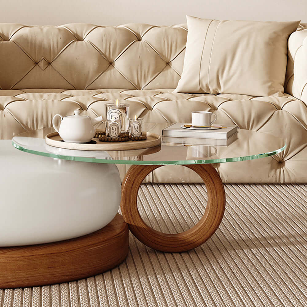 Round coffee table with glass top and solid wood legs, perfect for modern living rooms