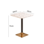 Rattan dining chairs with durable terrazzo table for an elegant dining setup