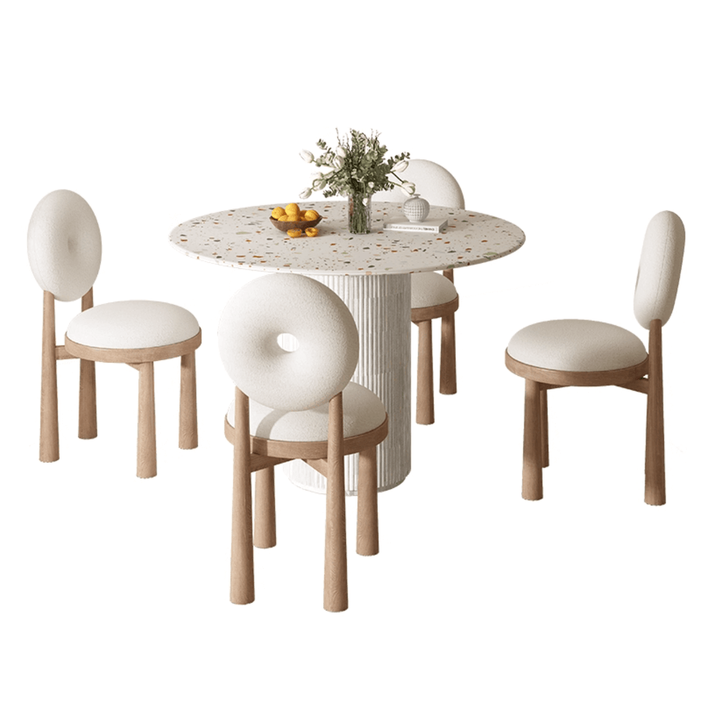 Round terrazzo dining table with soft wool upholstered chairs for a trendy home setup