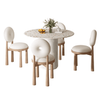 Round terrazzo dining table with soft wool upholstered chairs for a trendy home setup