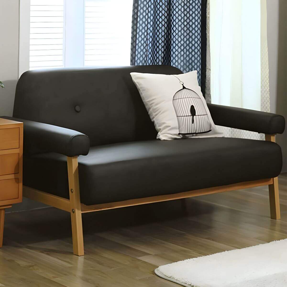 Black Scandinavian style small sofa with wood frame and faux leather upholstery