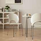 Stackable Scandinavian style dining chair with plastic seat, acrylic back, and silver legs