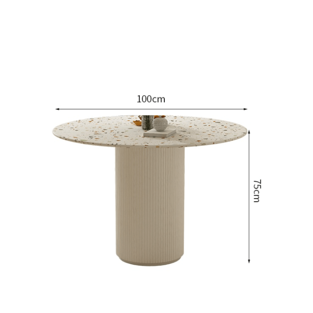 Round terrazzo dining table with soft wool upholstered chairs for a trendy home setup