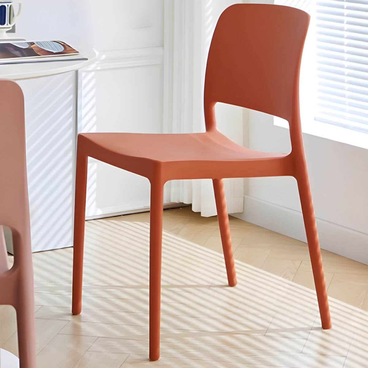 Scandinavian plastic and acrylic dining chair with low backrest and armless design