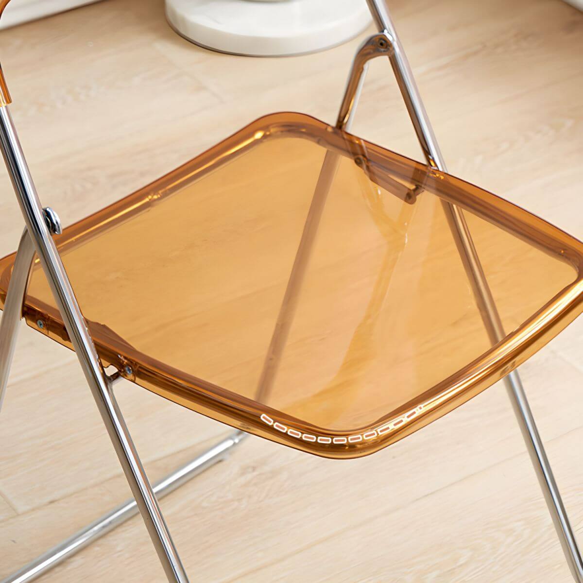 Modern collapsible open back side chair made of plastic and acrylic, ideal for kitchen and dining areas