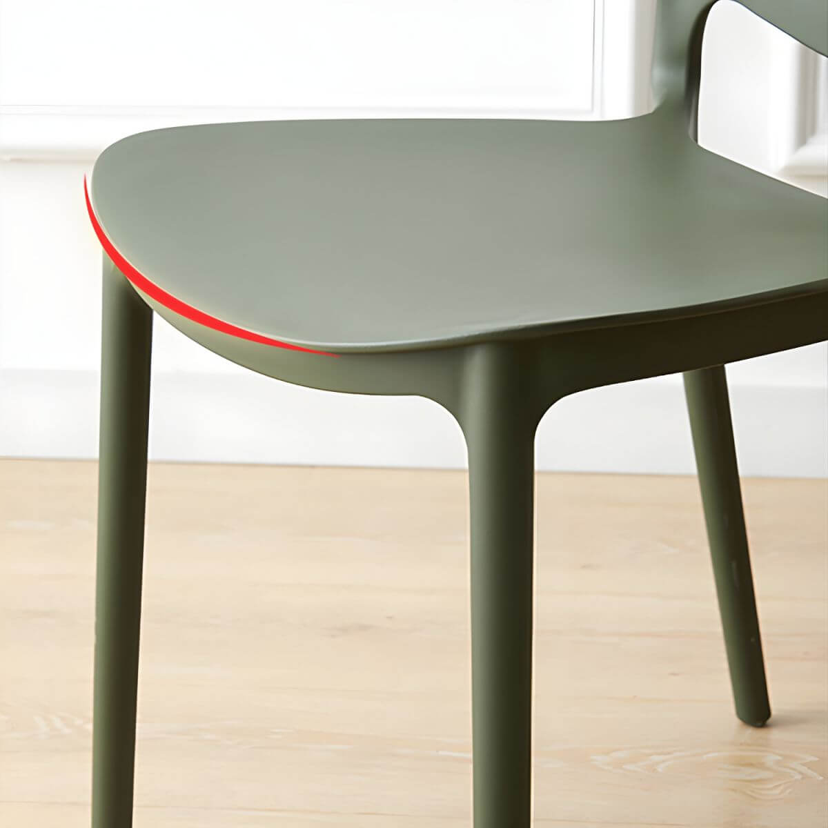 Scandinavian plastic dining chair with open back and four legs, ideal for home use