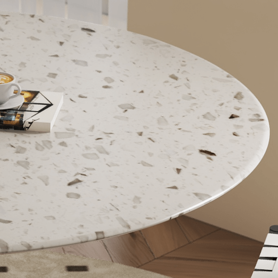Round terrazzo dining table featuring a stylish wooden and metal base for elegant interiors
