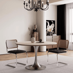 Round dining table with beige rock tabletop and stainless steel legs