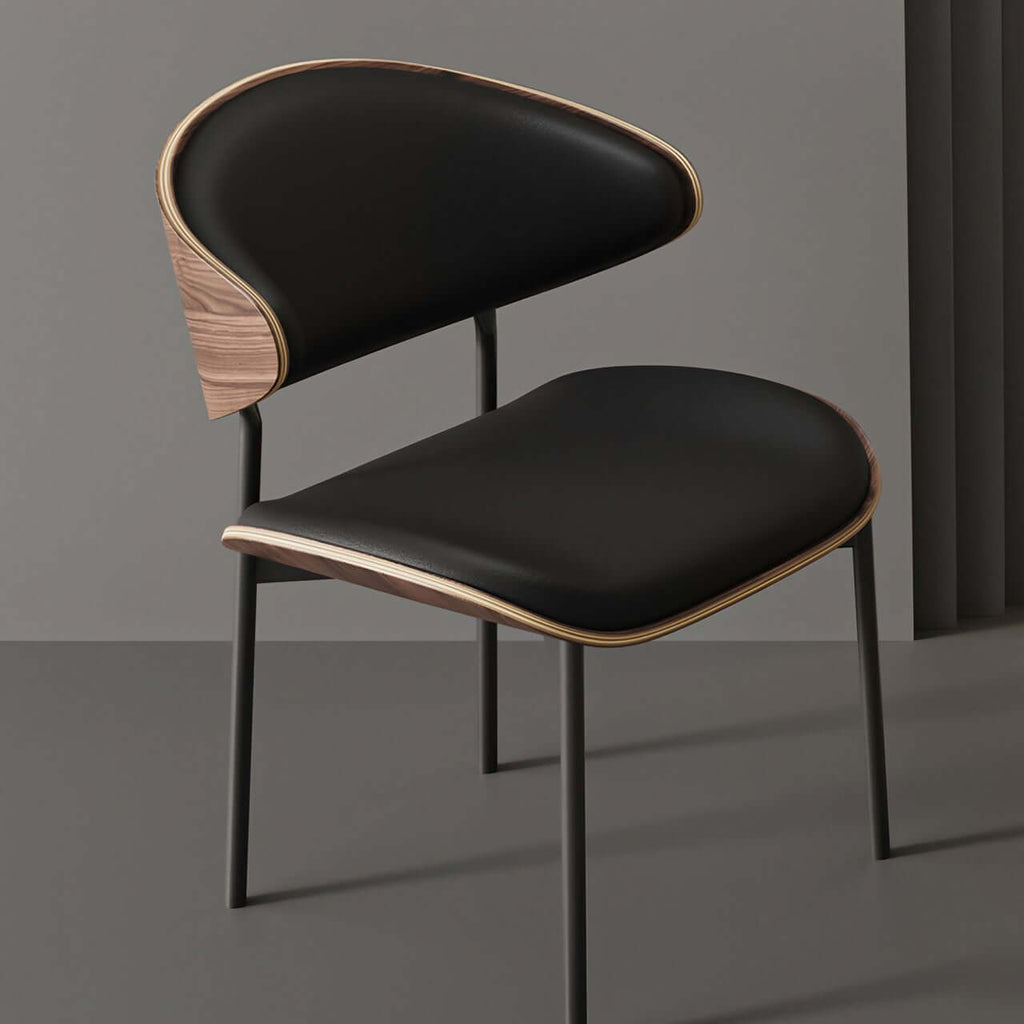 Black leather single dining chair with curved back, durable and minimalist luxury design