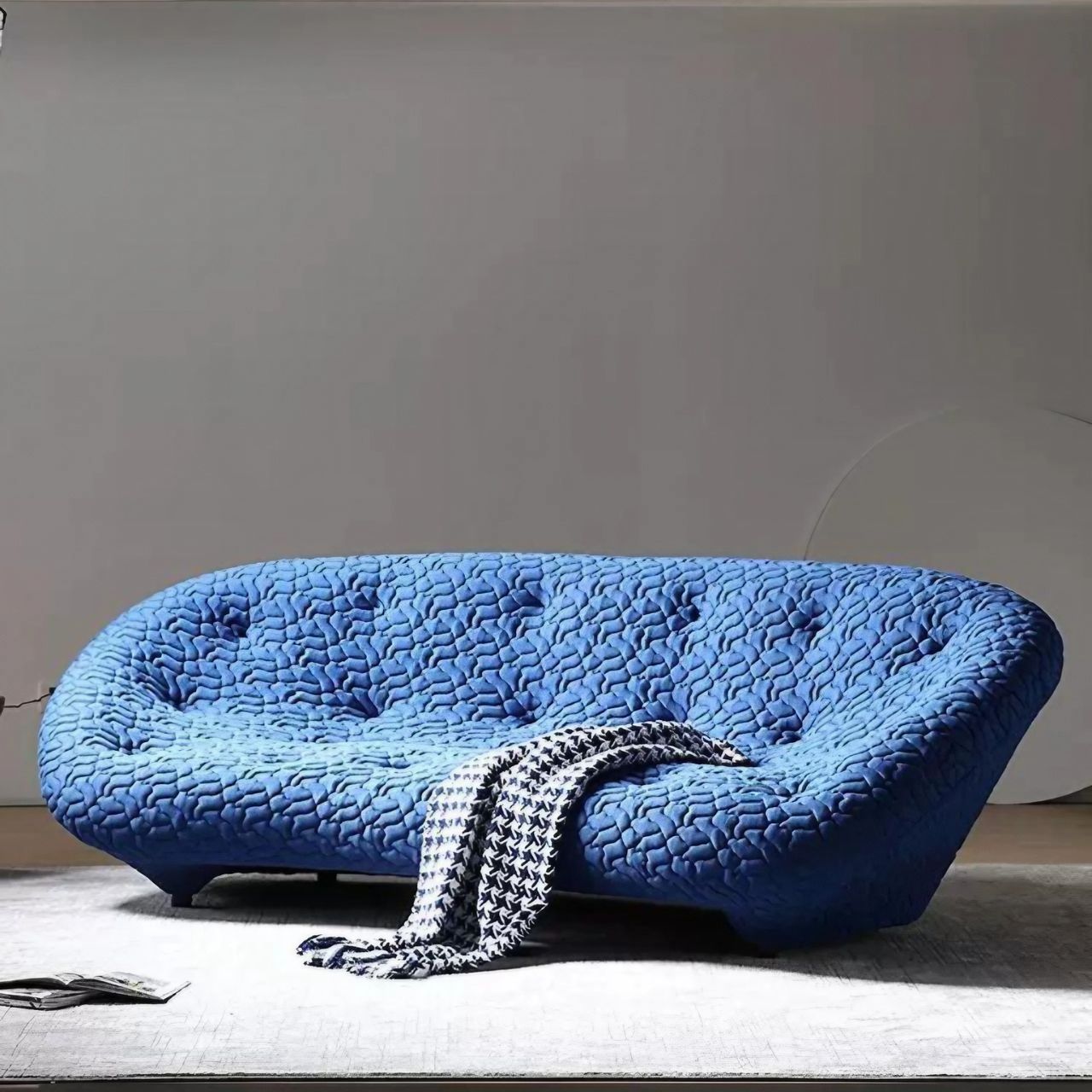 Blue minimalist shell sofa with 5D spacer fabric in a modern living room setting