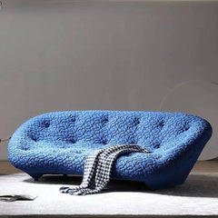 Blue minimalist shell sofa with 5D spacer fabric in a modern living room setting