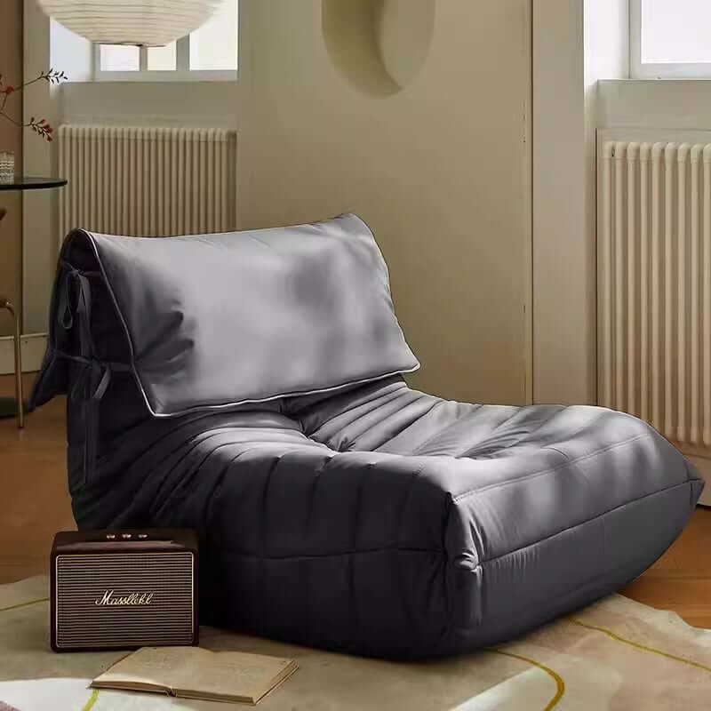 Burnt orange single lounge chair in PU leather with caterpillar design, Togo sofa style