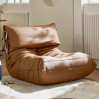 Burnt orange single lounge chair in PU leather with caterpillar design, Togo sofa style