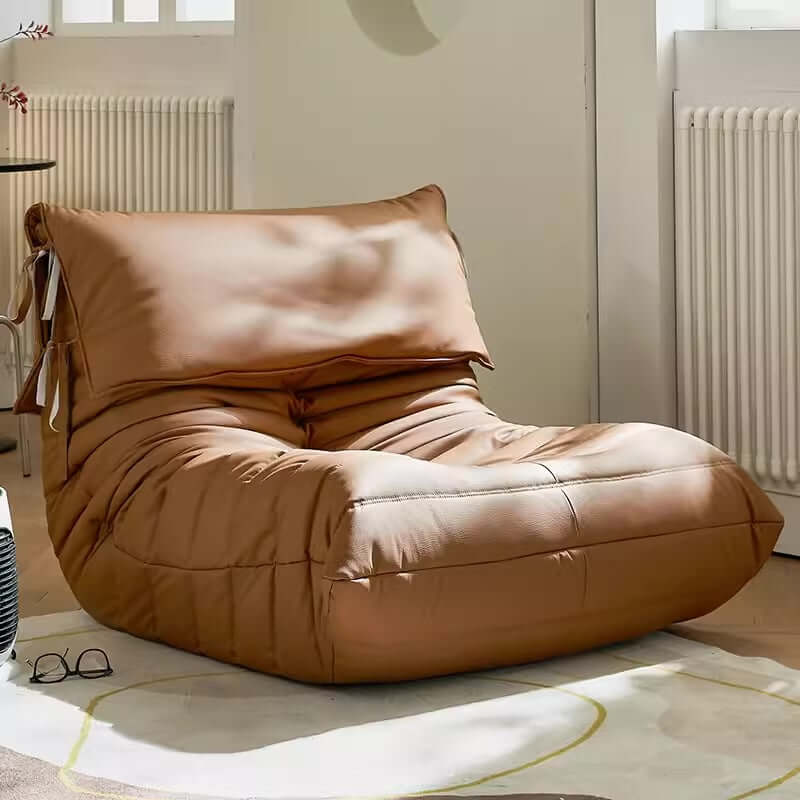 Burnt orange single lounge chair in PU leather with caterpillar design, Togo sofa style