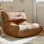 Burnt orange single lounge chair in PU leather with caterpillar design, Togo sofa style