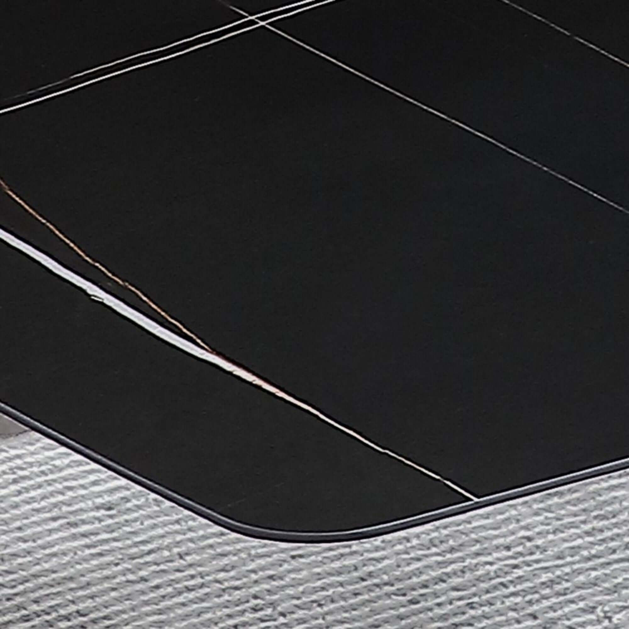 Black marble dining table with sintered stone top and X-base, measuring 70.87 inches