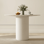 Round terrazzo dining table with soft wool upholstered chairs for a trendy home setup