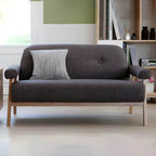 Black Scandinavian style small sofa with wood frame and faux leather upholstery