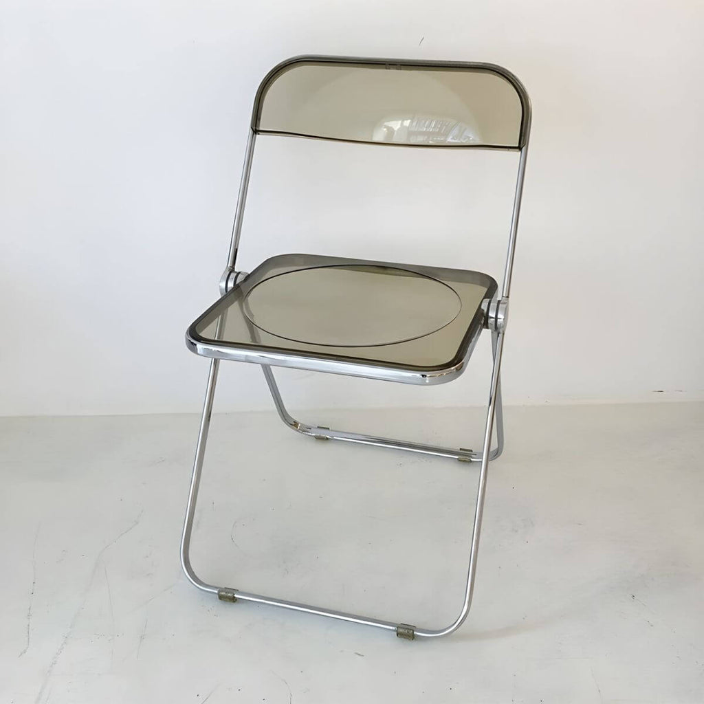 Contemporary acrylic folding armless chair with open back, ideal for dining rooms
