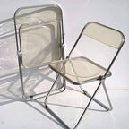 Contemporary acrylic folding armless chair with open back, ideal for dining rooms