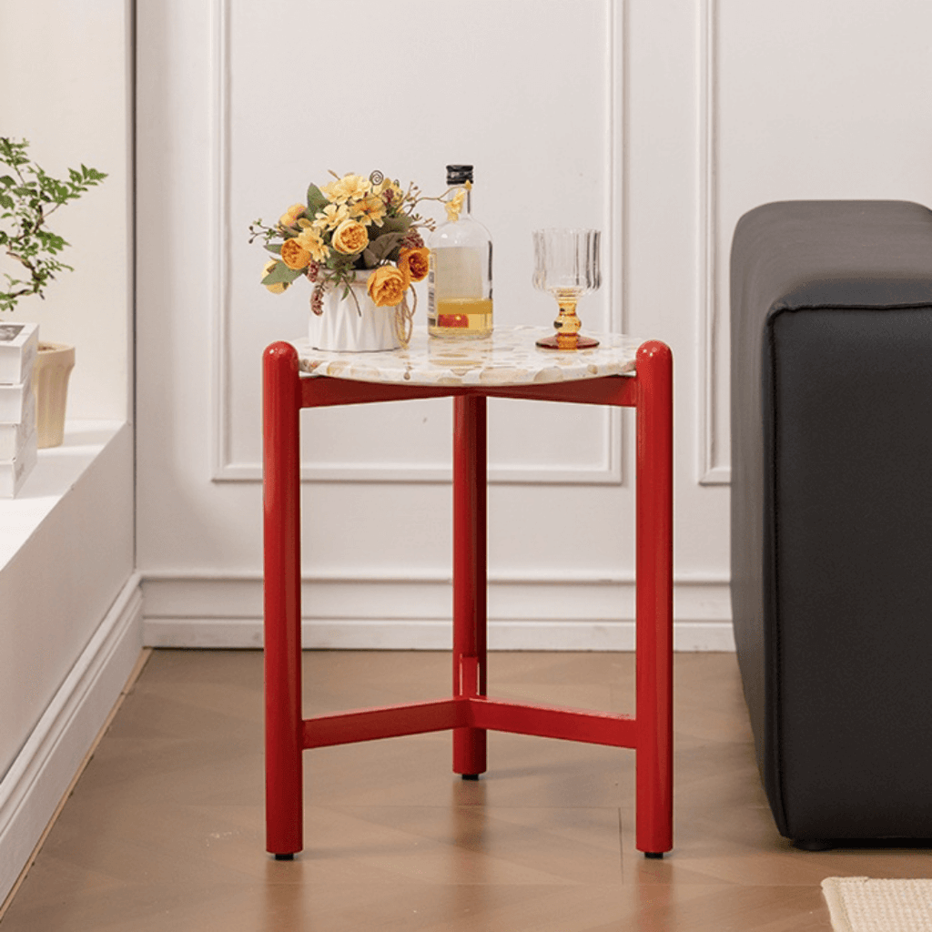 Round side table with vibrant red terrazzo top, featuring a modern minimalist design