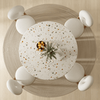 Round terrazzo dining table with soft wool upholstered chairs for a trendy home setup