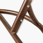 Metal porch swing with stand, cushions, and chain for comfortable outdoor seating