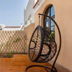 Metal upholstered porch swing egg chair with stand and chain, seating for two in cocoa and cream colors