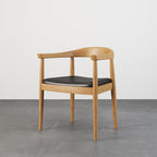 Set of four modern curved back dining chairs with walnut wooden frame and upholstered leather seats