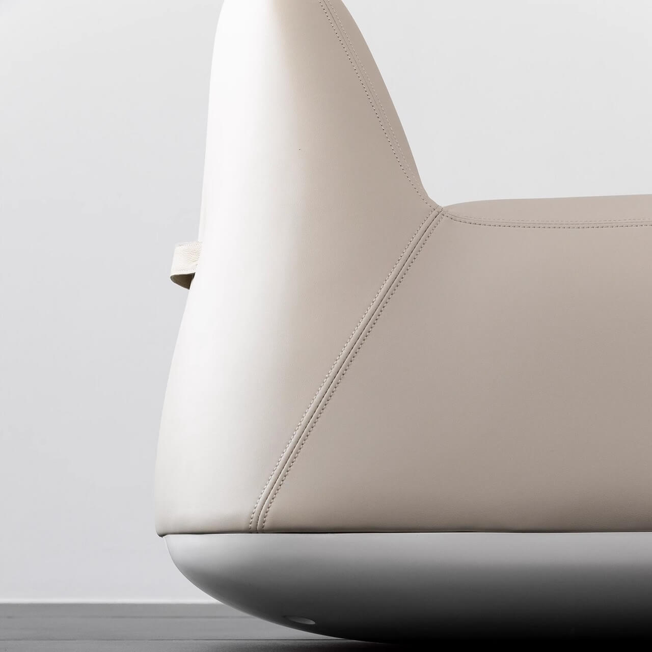 White microfiber leather tumbler sofa with a chic, cute armless design for modern living rooms