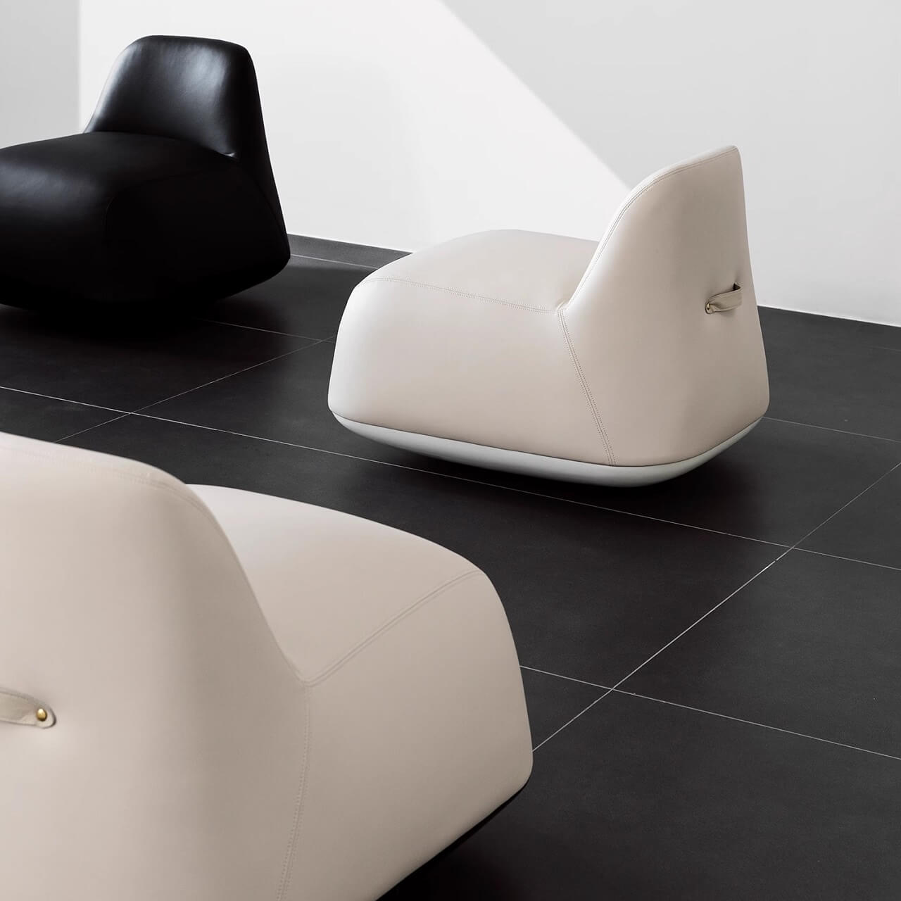 White microfiber leather tumbler sofa with a chic, cute armless design for modern living rooms