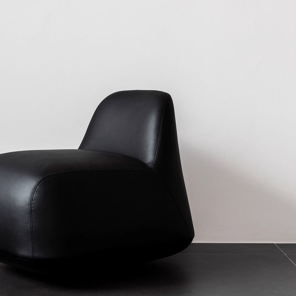 White microfiber leather tumbler sofa with a chic, cute armless design for modern living rooms