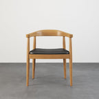 Set of four modern curved back dining chairs with walnut wooden frame and upholstered leather seats