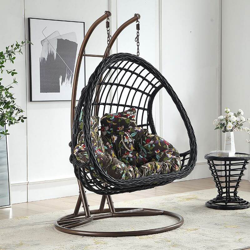 Tropical upholstered porch swing with metal chain and included stand for outdoor relaxation