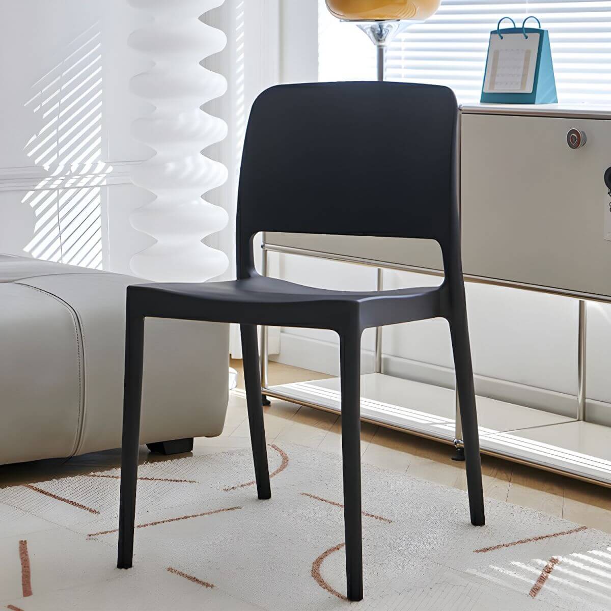 Scandinavian plastic and acrylic dining chair with low backrest and armless design