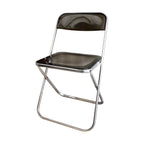 Contemporary acrylic folding armless chair with open back, ideal for dining rooms