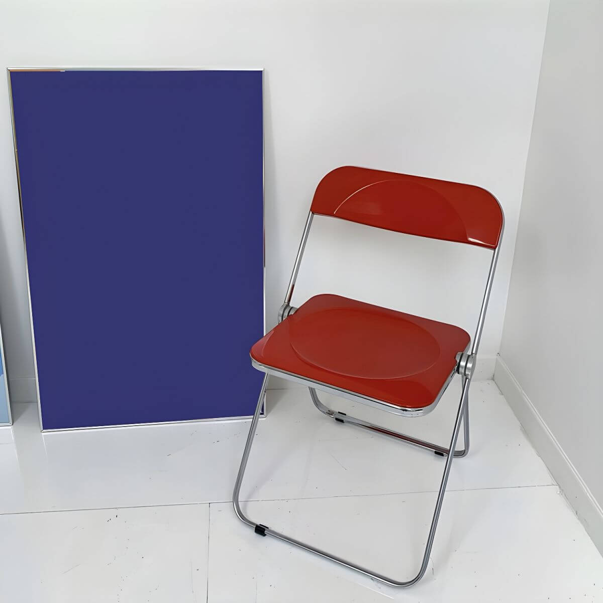 Contemporary acrylic folding armless chair with open back, ideal for dining rooms