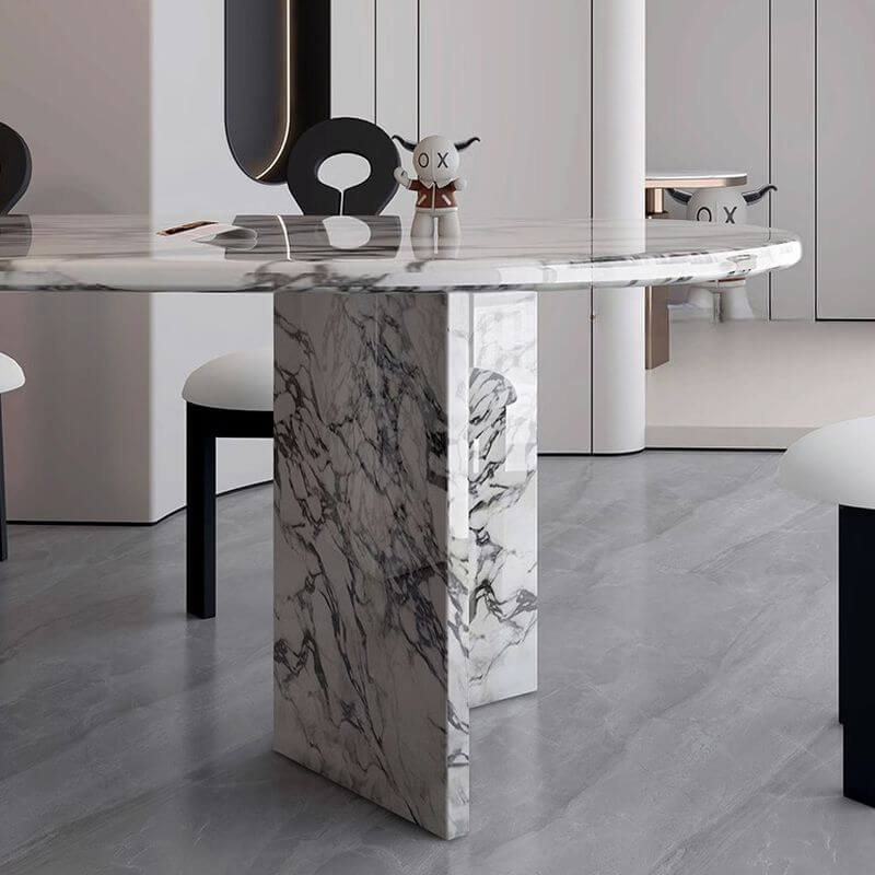 Oval dining table with white marble top and fixed base, perfect for contemporary dining rooms