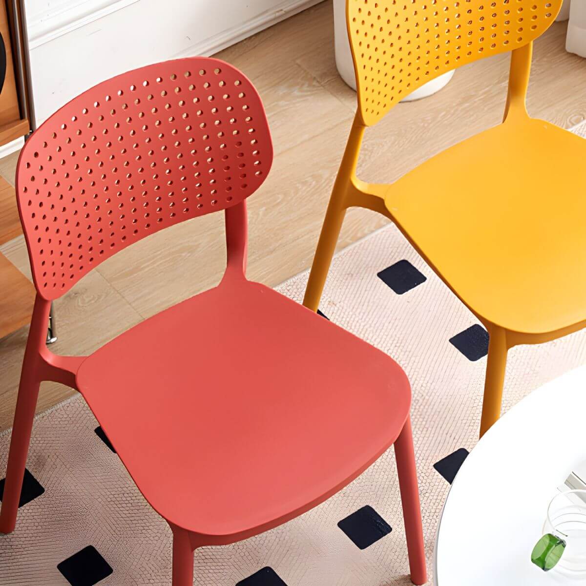 Stackable Scandinavian style plastic and acrylic side chair with low back for dining