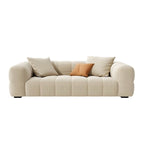 Beige upholstered wood sofa with square arms and sewn pillow back for modern living rooms