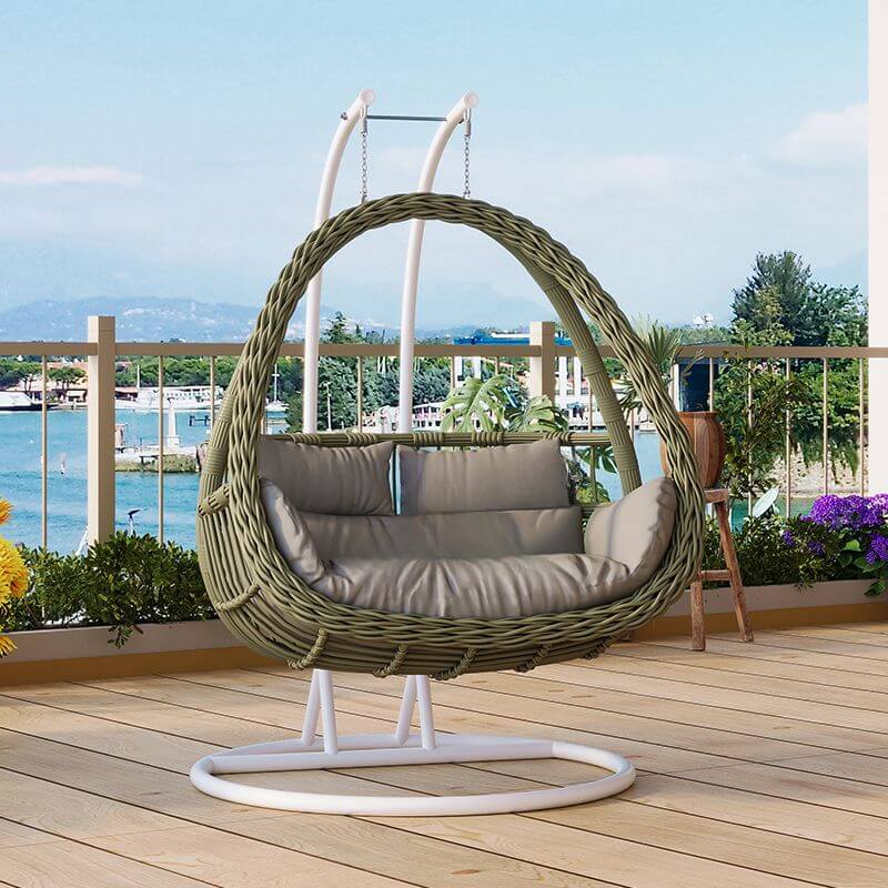 Pink metal 2-seater porch swing with stand, chain, and cushions for outdoor seating