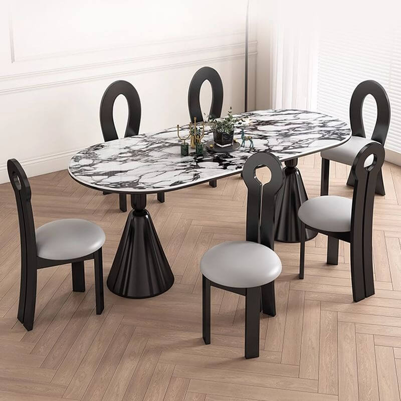 Oval marble dining table set with dual footing, solid back panel, and cushioned chairs