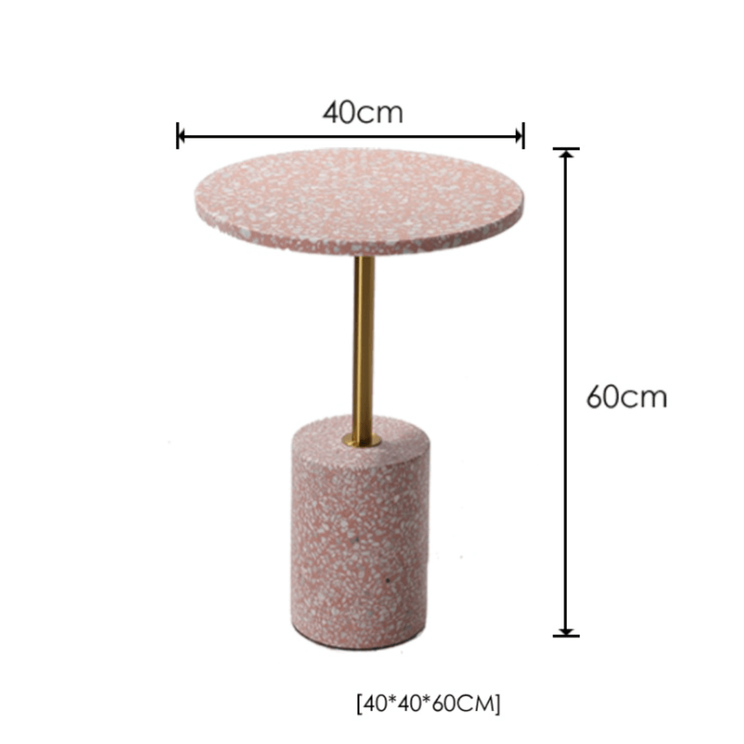 Pink terrazzo coffee table with gold accents in a modern minimalist design