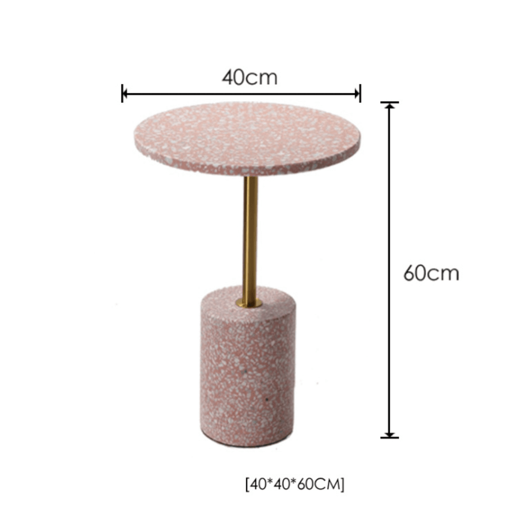 Pink terrazzo coffee table with gold accents in a modern minimalist design