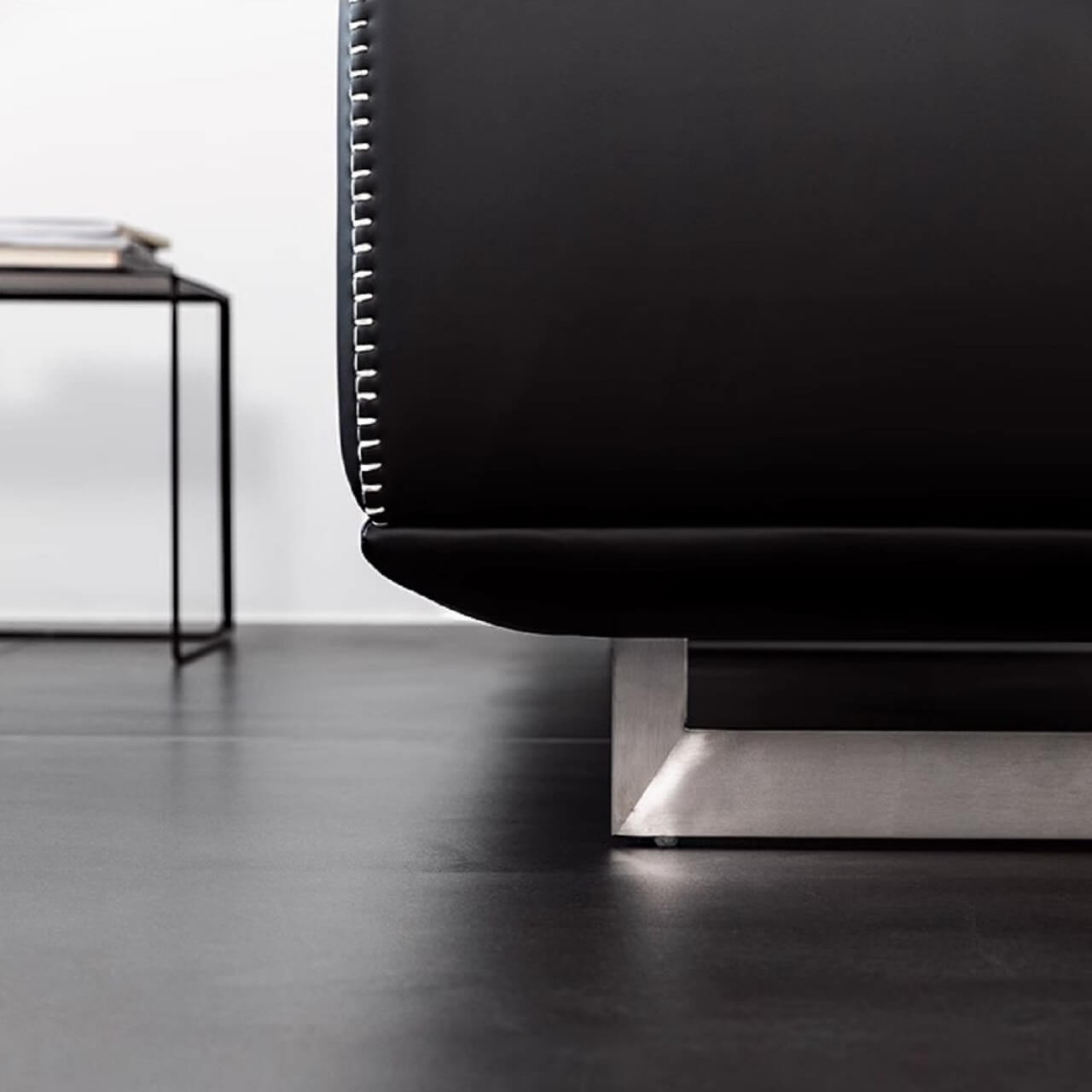 Black microfiber leather sofa with minimalist design, seats up to 3 people