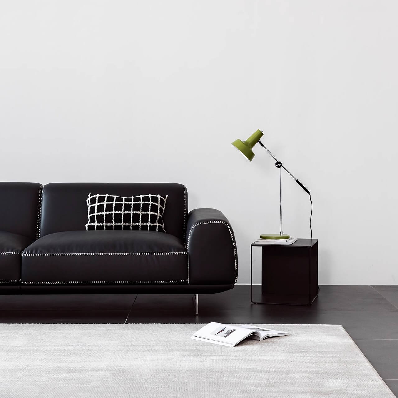 Black microfiber leather sofa with minimalist design, seats up to 3 people