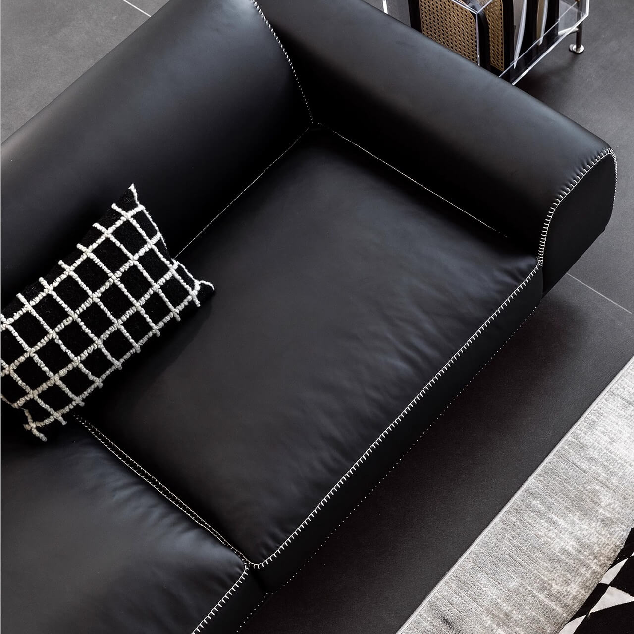 Black microfiber leather sofa with minimalist design, seats up to 3 people