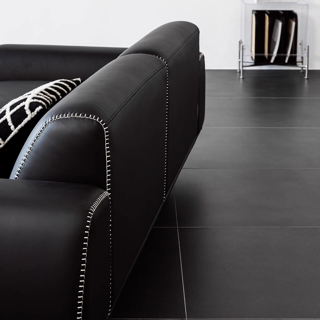 Black microfiber leather sofa with minimalist design, seats up to 3 people