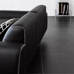 Black microfiber leather sofa with minimalist design, seats up to 3 people