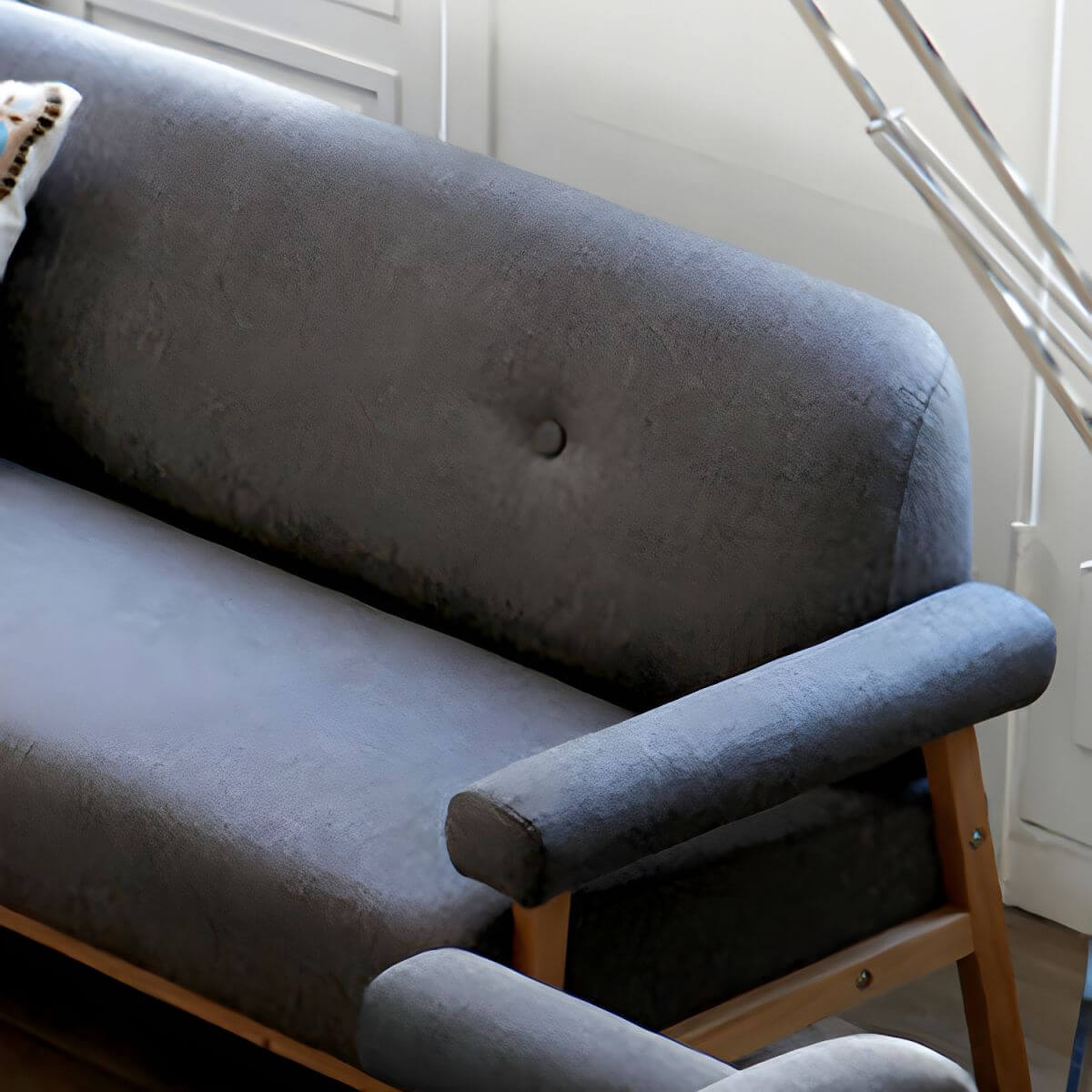 Black Scandinavian style small sofa with wood frame and faux leather upholstery